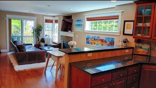 a living room with a kitchen with a counter top at 4 Story Lakeside Home In Heart of Lake Union - Queen Anne Neighborhood in Seattle