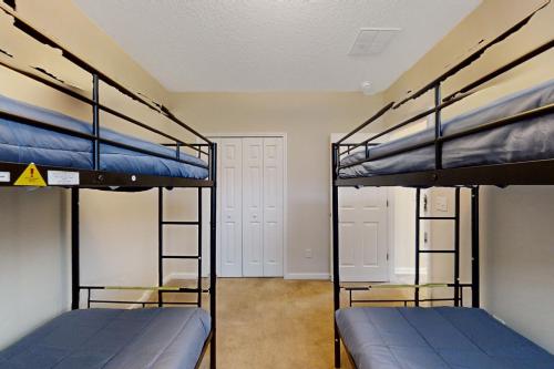 two bunk beds in a room with two doors at Carson Lake Escape in Jacksonville