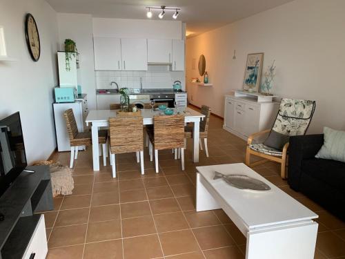 a kitchen and living room with a table and chairs at Thelighthouse Porto Santo in Porto Santo