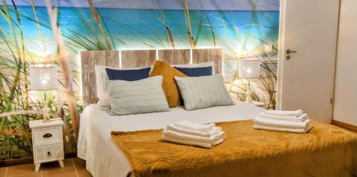 a bedroom with a bed with towels on it at Thelighthouse Porto Santo in Porto Santo