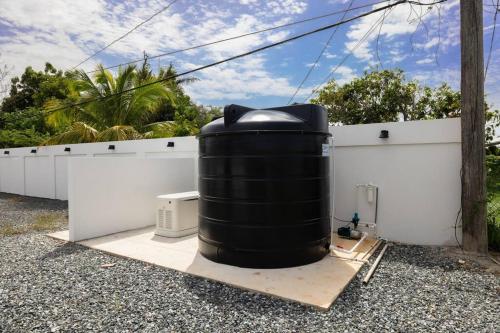 a large black tank sitting on top of a building at Ramey Cir D, near airport, beaches W/KING Bed. in Aguadilla