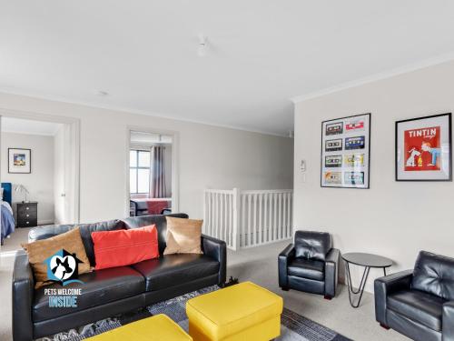 a living room with a couch and two chairs at Big House with Views and Fab Pop Culture Vibe in Encounter Bay
