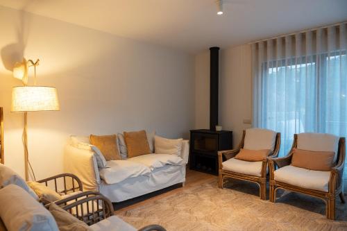 a living room with a couch and two chairs at Quinta da Ribeirinha - Douro River in Paços de Gaiolo