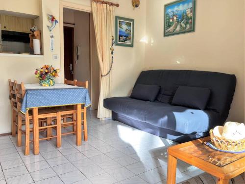 un salon avec un canapé et une table dans l'établissement Appartement Climatisé avec Terrasse - 100m de la Plage - 4 couchages - Parking et Ménage Inclus - FR-1-251-444, au Lavandou