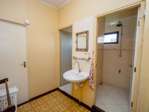 een badkamer met een wastafel, een toilet en een spiegel bij Stunning 3-Bed House in Paramaribo Marie's place in Paramaribo