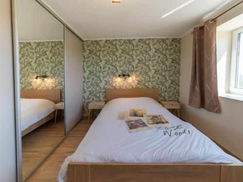 a bedroom with two beds and a mirror at Splendid home near the Spa Francorchamps circuit in Stavelot