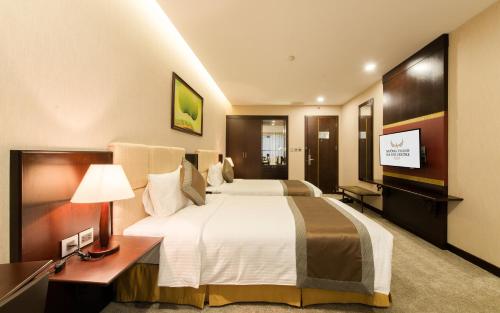 a hotel room with a large bed and a television at Muong Thanh Hanoi Centre Hotel in Hanoi