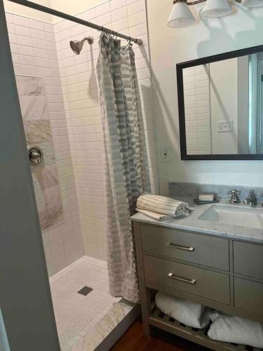 a bathroom with a shower and a sink at Over-Time in Galveston
