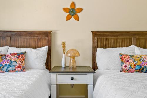 a bedroom with two beds and a table with a lamp at 13-Acre Private Estate, Private Lake, Private Golf Range, Private Forest & Hiking Trails in Ross Corner