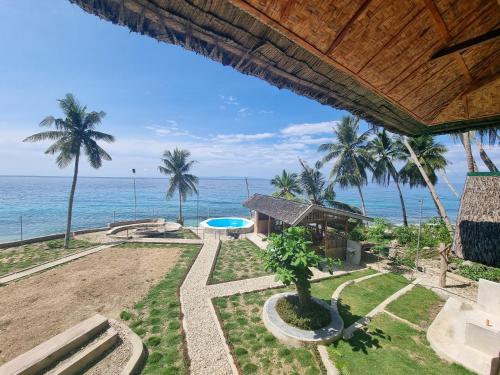 an aerial view of a resort with the ocean at Hagdan Reef Dive Spot by HiveRooms in Oslob