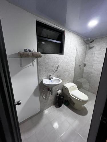a bathroom with a toilet and a sink at Cabaña Los Cedros in La Vega