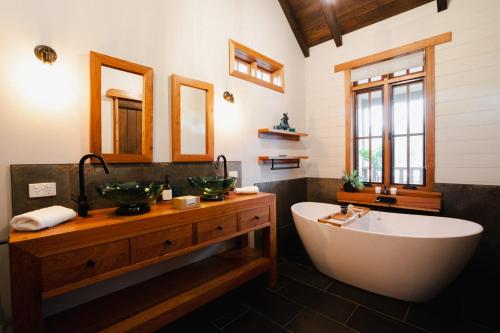 a bathroom with a tub and a sink and a bath tub at Eliza's in Bright