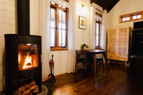 a living room with a fireplace and a table at Eliza's in Bright