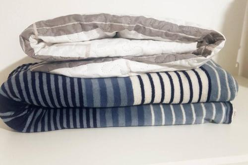 two stacks of pillows sitting on top of each other at Studio 501 Campinas SP in Campinas