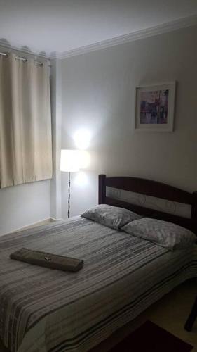 a bedroom with a bed with a laptop on it at Studio 501 Campinas SP in Campinas