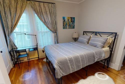 a bedroom with a bed and a large window at Renovated 3/2 * Craftsman Home * Perfect Location in Memphis