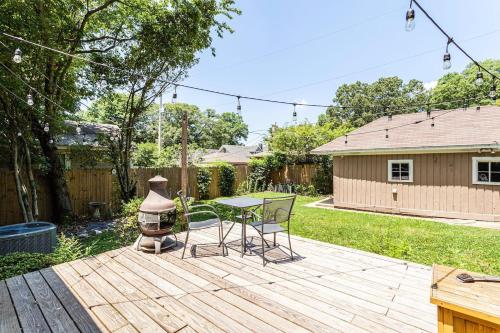 a backyard with a table and chairs on a wooden deck at Renovated 3/2 * Craftsman Home * Perfect Location in Memphis