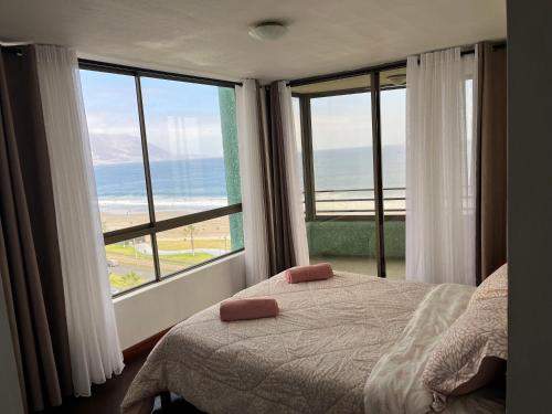 1 dormitorio con cama y vistas al océano en Aguamarina,Apart, en Iquique