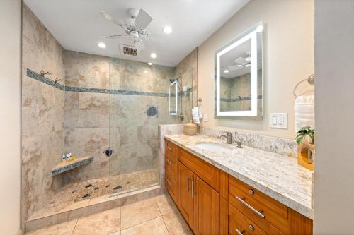 a bathroom with a large sink and a shower at Kulakane 310 in Kahana