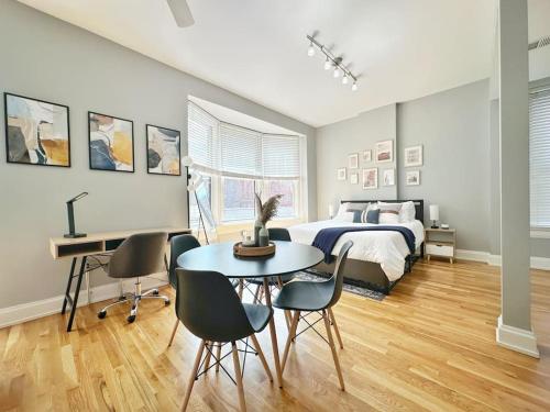 a bedroom with a bed and a table and chairs at Boho Studio Loft Meets Luxury in OTR Cincinnati! in Cincinnati