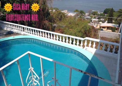 a blue swimming pool on top of a building at CASA MARY in Tequesquitengo