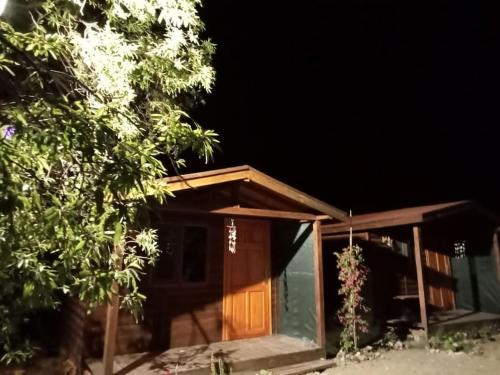 a house with a wooden door at night at Doğal,Kaliteli,Huzurlu,Avantajli in Döşeme