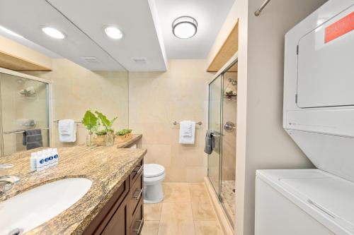 a bathroom with a toilet and a sink and a shower at Kaleialoha 213 in Lahaina