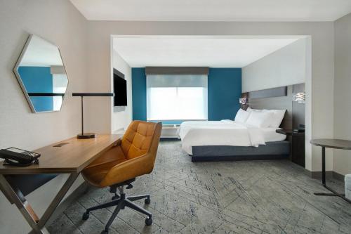 a hotel room with a bed and a desk and a chair at Holiday Inn Express Marietta - Atlanta Northwest by IHG in Marietta