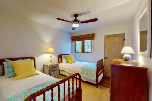a bedroom with two beds and a ceiling fan at Marsh Haven in Southport
