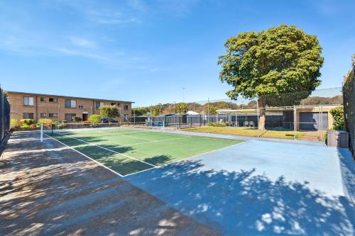 a tennis court in front of a building at Apollo Unit 1 - Ground Floor - A Block in Narooma
