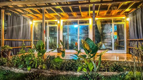 a house with plants in the front of it at Suites Bocas del Toro in Carenero