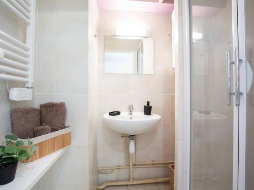 a white bathroom with a sink and a shower at Studio 4 personnes avec balcon à Saint-Lary-Soulan - FR-1-296-477 in Saint-Lary-Soulan
