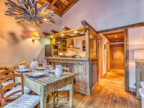une cuisine et une salle à manger avec une table et des chaises dans l'établissement Charmant appartement au cœur de Courchevel 1850, 73m², 4 pers, proche pistes, balcon, hammam, WiFi - FR-1-631-164, à Courchevel