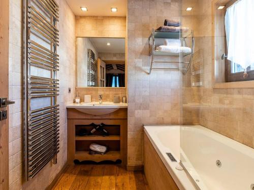 a bathroom with a tub and a sink and a mirror at Charmant appartement au cœur de Courchevel 1850, 73m², 4 pers, proche pistes, balcon, hammam, WiFi - FR-1-631-164 in Courchevel
