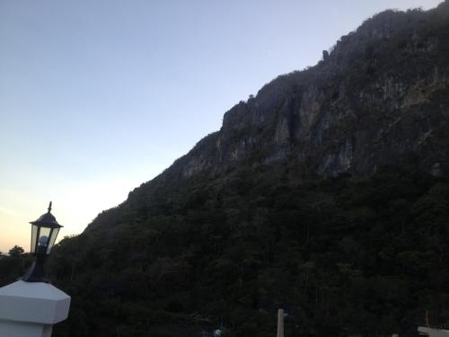 a street light in front of a mountain at Raje Residence in El Nido