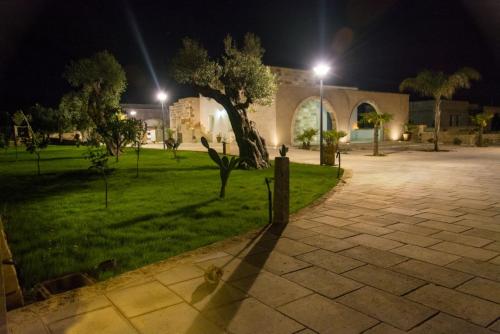 a park at night with a tree and a building at Relais Tenuta Campì in Martano