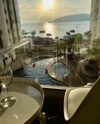 a view of a swimming pool from a hotel window at The Shore Kota Kinabalu by Ems Executive Suites Seaview in Kota Kinabalu