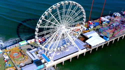 a ferris wheel on a pier next to the water at Boardwalk CozySuites Condo with kitchen 33 in Atlantic City