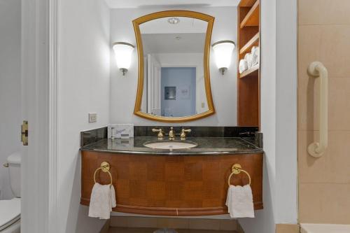 a bathroom with a sink and a mirror at Boardwalk CozySuites Condo w kitchen 36 in Atlantic City
