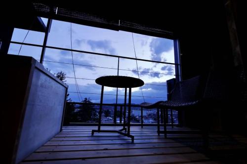 a room with a table and chairs in front of a window at Matsumoto Jujo in Matsumoto