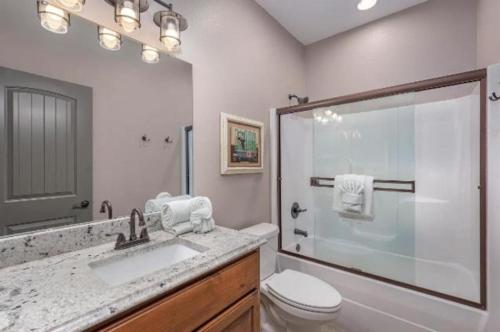 a bathroom with a shower and a toilet and a sink at SPACIOUS FAMiLY HOME in Hollister
