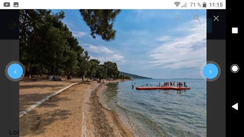 a boat in the water next to a beach at RiLen-House in Akbük
