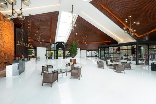 a lobby with tables and chairs in a building at Handara Golf & Resort Bali in Bedugul