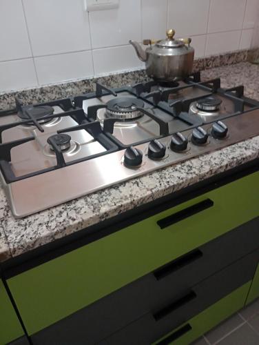 a stove top with a pot on top of it at La casa de Emma in Cordoba