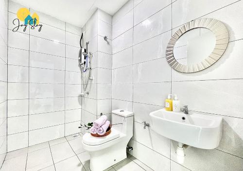 a bathroom with a toilet and a sink and a mirror at Amber Cove l Luxury Seaview 2BR l 6-8pax l GamesRoom l City Centre l Jonker St by Jay Stay in Melaka