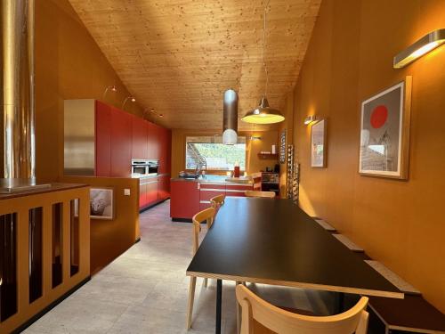 a kitchen with a black table and chairs at Le Nid - Versegere near Verbier - 4 Valleys in Versegeres 