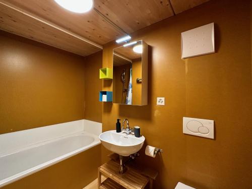a bathroom with a sink and a bath tub at Le Nid - Versegere near Verbier - 4 Valleys in Versegeres 