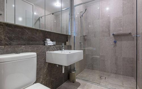 a bathroom with a toilet and a sink and a shower at Glebe Park 145 Canberra City ACT in Canberra