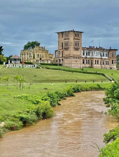 a castle with a river in front of it at Homestay Rezeki Batu Gajah in Batu Gajah