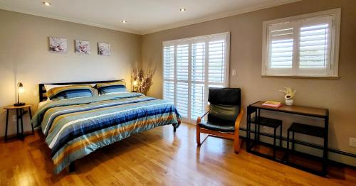 a bedroom with a bed and a desk and a chair at Vivi's Home in Vancouver